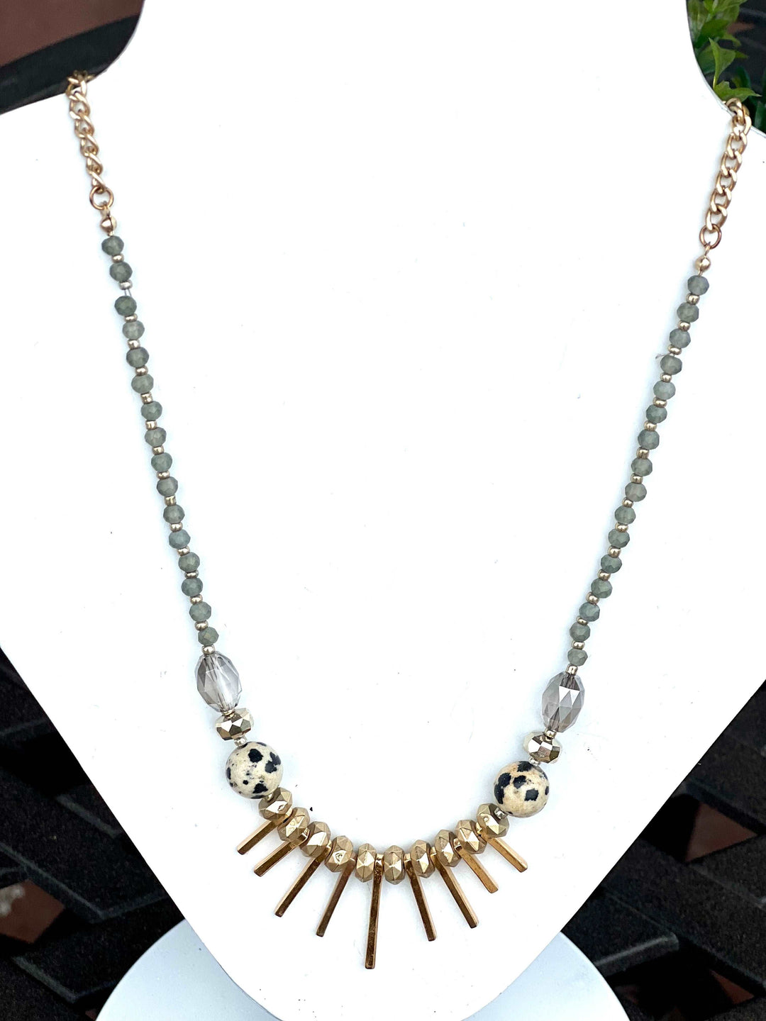 Gold necklace with gray beads and bars